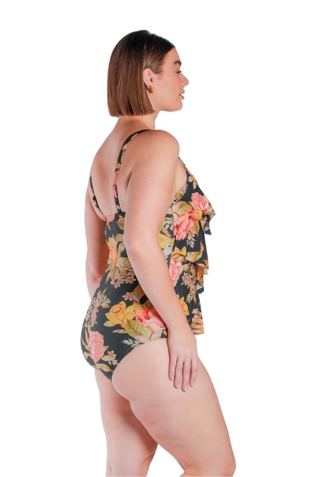 Plus size brunette model wearing a three tiered ruffled swimsuit in black based floral print Australia