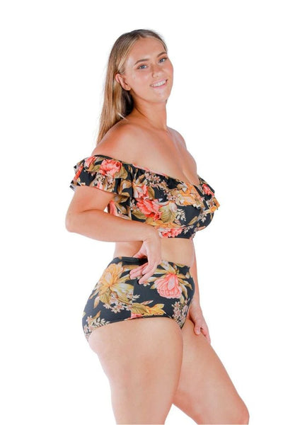 Side of model wearing plus size bikini top with shelf bra in black based floral print