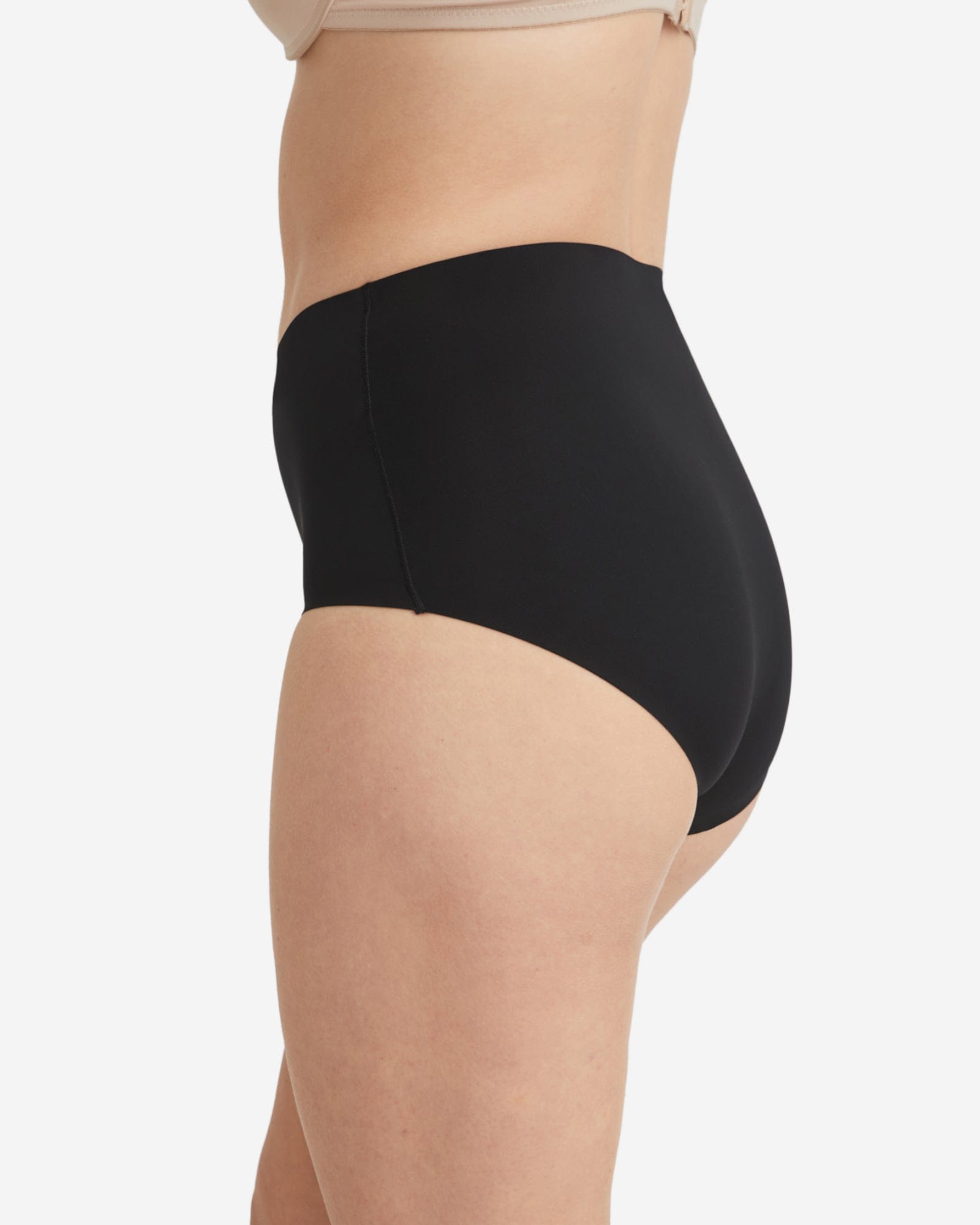 Black high-waisted underwear worn by a person on a white background