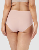 Light pink high-waisted underwear worn by a person on a plain background
