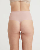 Beige shapewear worn by a person on a light gray background