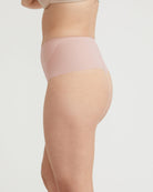 Beige shapewear being worn on a plain background