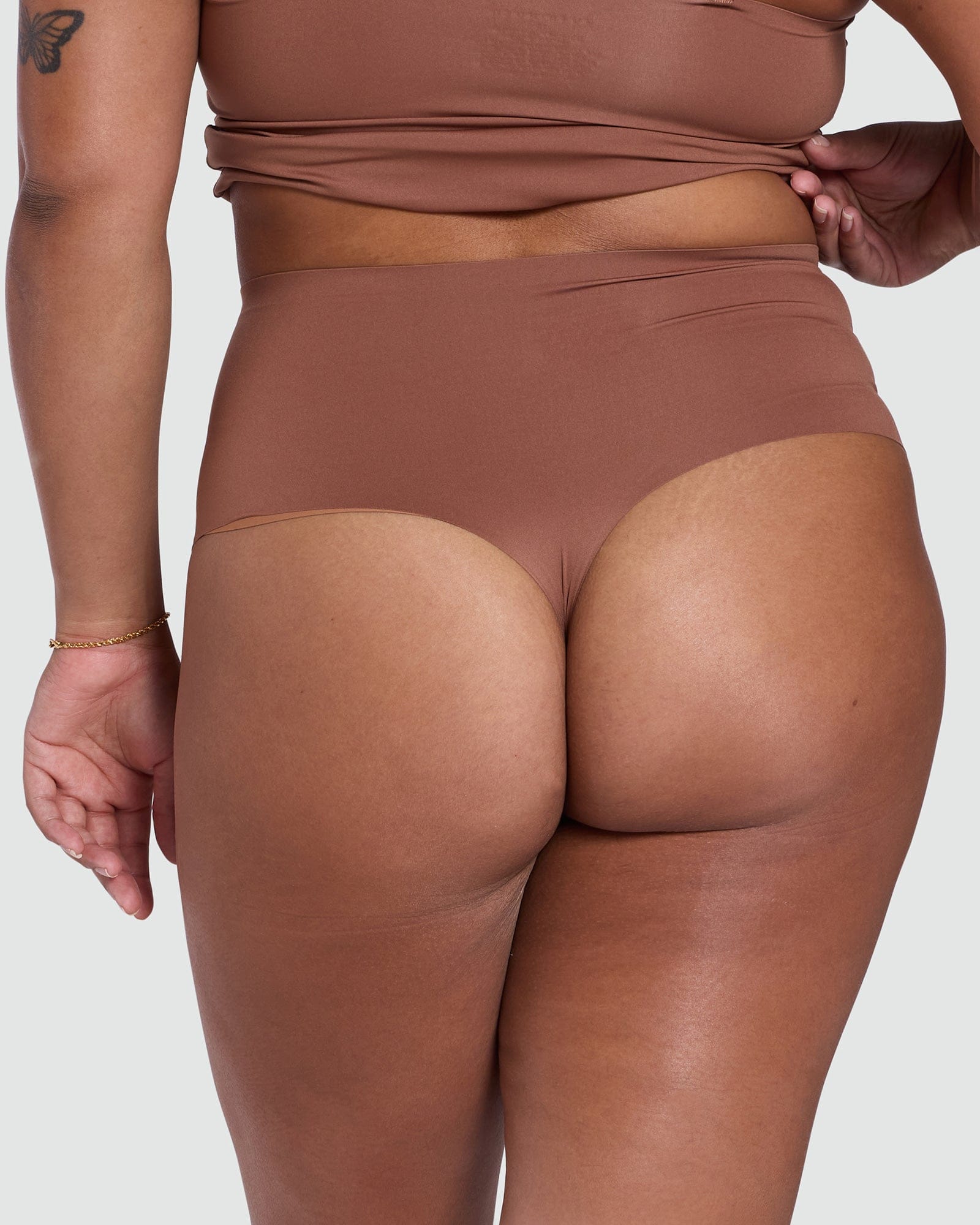 Brown high-waisted bikini bottom on a plain background