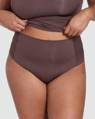 Brown high-waisted bikini bottom worn by a person on a white background