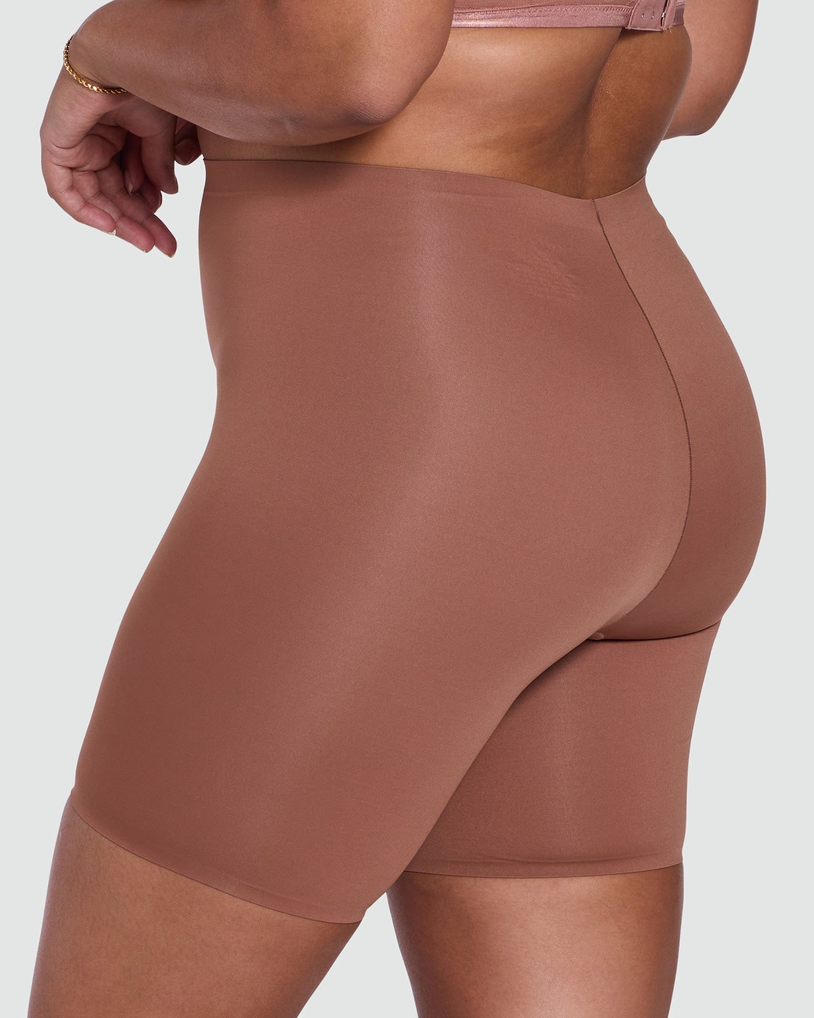 Brown shapewear shorts on a plain background