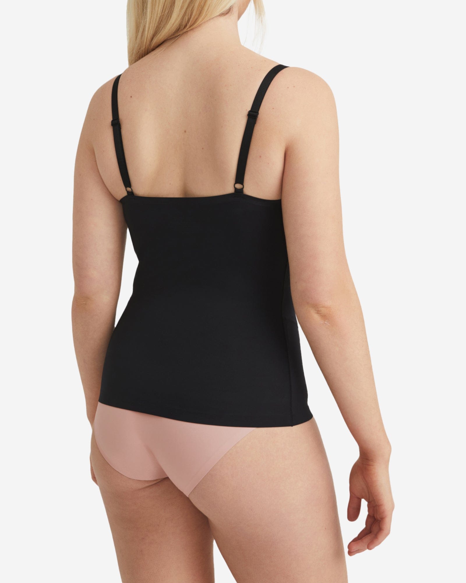 Black tank top worn by a person on a white background