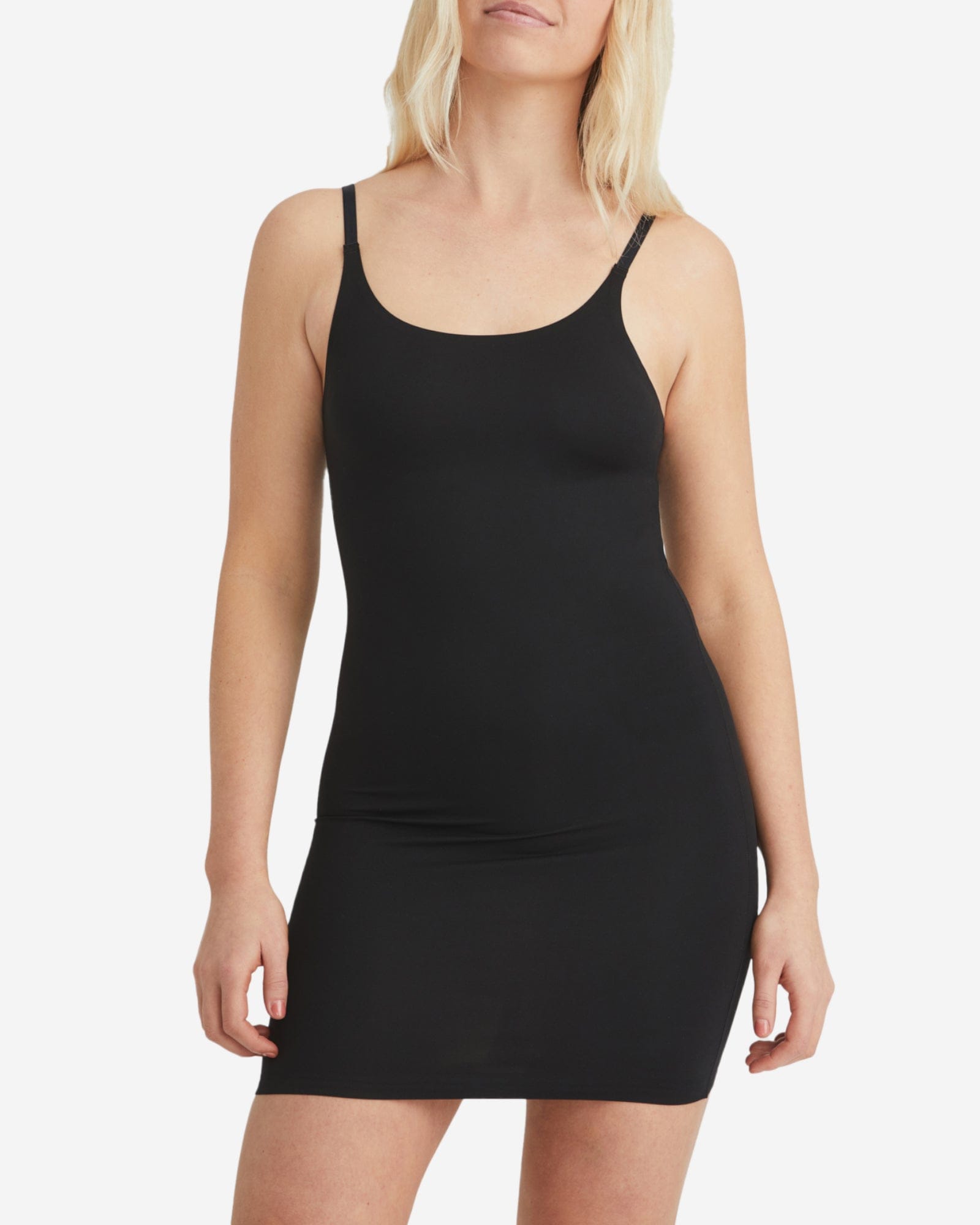 Woman wearing a black tank dress on a white background