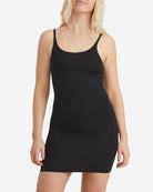 Woman wearing a black tank dress on a white background
