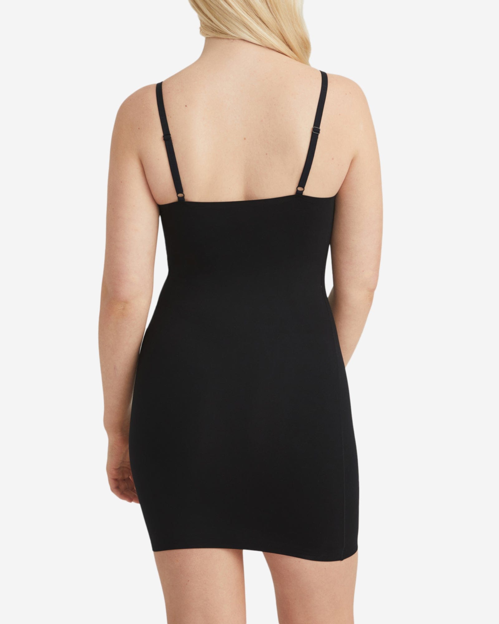 Black slip dress worn by a person on a white background