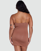 Brown slip dress worn by a person on a white background