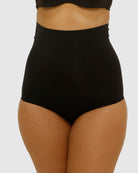 Black high-waisted underwear on a plain background