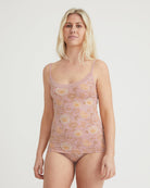 Woman wearing a floral-patterned tank top and underwear set on a plain background