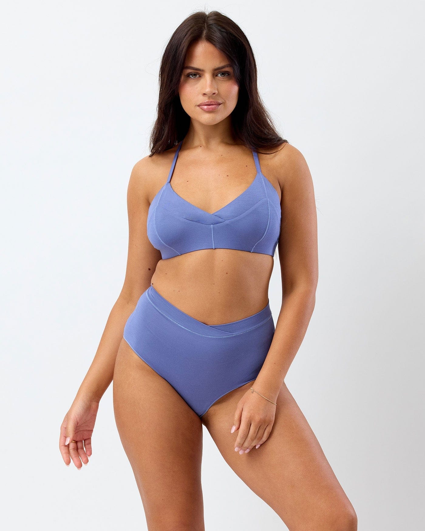 Woman wearing a purple bikini set on a white background