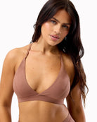 Woman wearing a brown bikini top on a white background