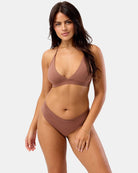 Woman wearing a brown sports bra set on a white background