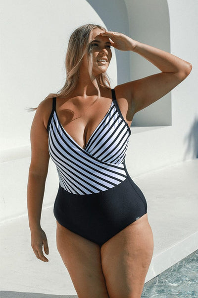 Blonde model wearing black and white stripe swimsuit
