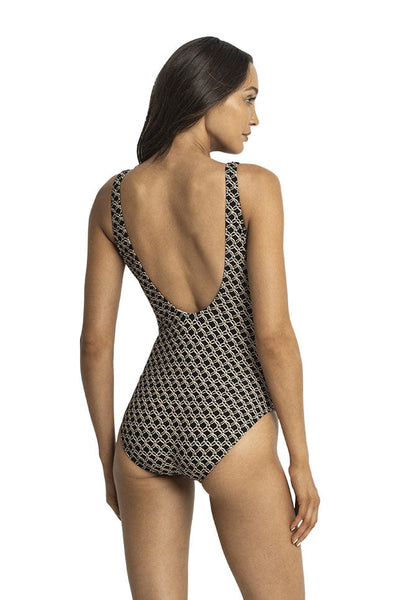 Model shows back of black and gold swimsuit