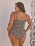Woman wearing a patterned Jantzen swimsuit against a light background