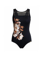 A black one-piece swimsuit featuring a large floral print in white, beige, and brown on the left side, with sheer black mesh shoulder straps, shown against a plain white background.