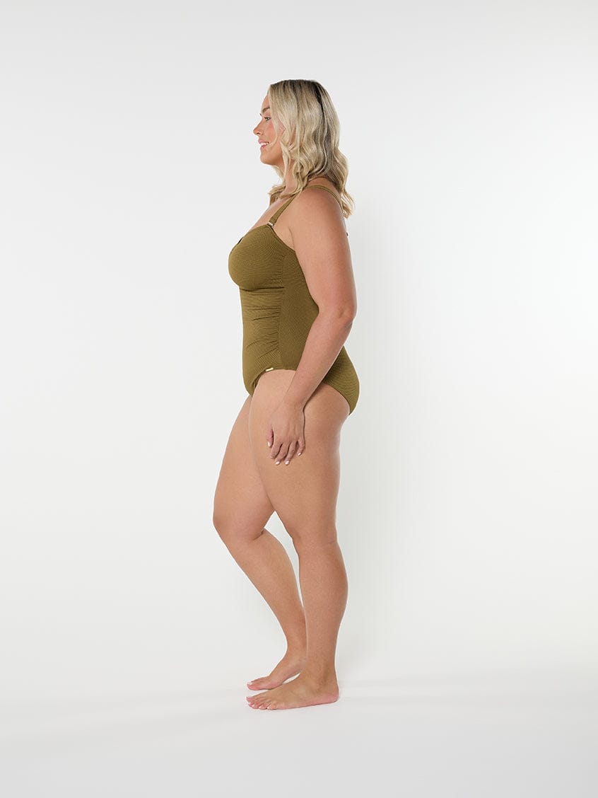 Woman wearing a green swimsuit on a white background