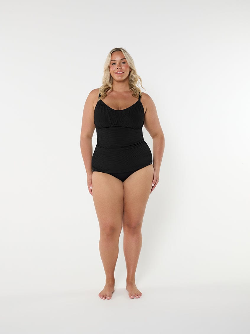 Woman wearing a black swimsuit on a white background