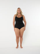 Woman wearing a black swimsuit on a white background