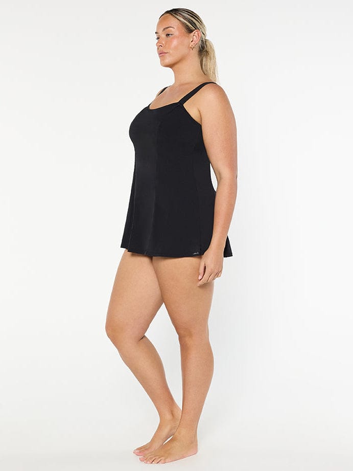 Woman wearing a black slip against a white background