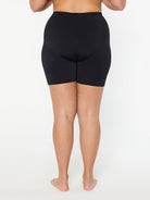 Person wearing black shorts on a white background