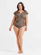 Woman wearing a leopard print swimsuit on a white background