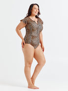 Woman wearing a leopard print swimsuit on a white background