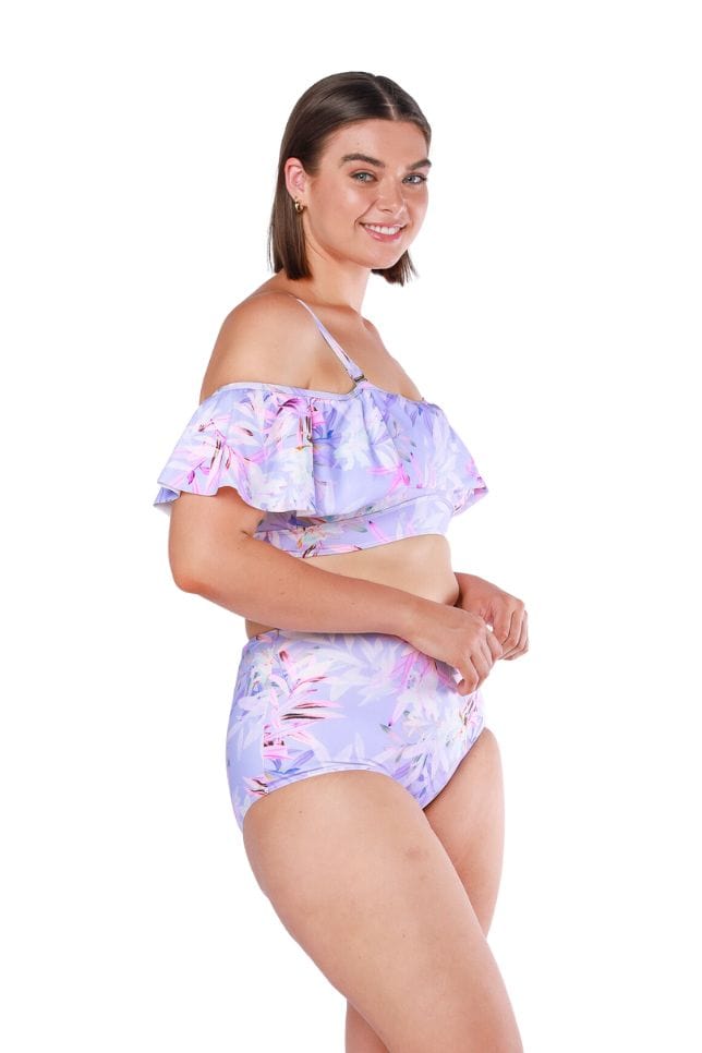 Brunette curve model wearing ruffle lilac floral bikini top with removable straps