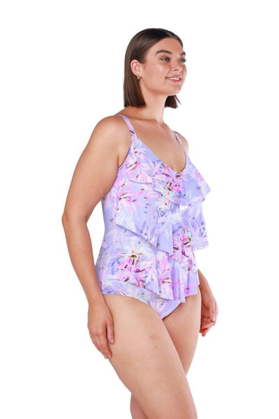 Brunette plus size model wearing three tiered lilac and pink floral print