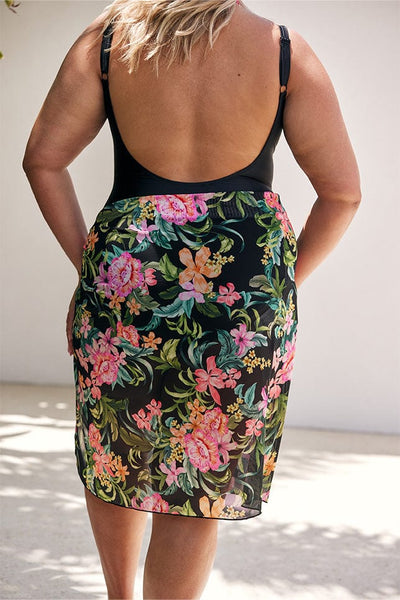 Model showing back of tropical floral on black mesh sarong