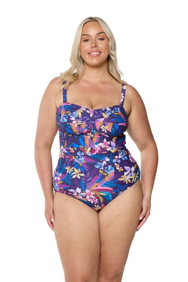 Front of model in studio wearing bandeau one piece in floral print with removable straps 