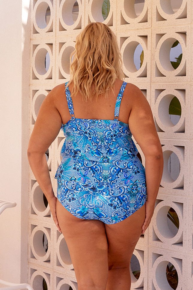 Blonde model showing back of blue patterned tankini top