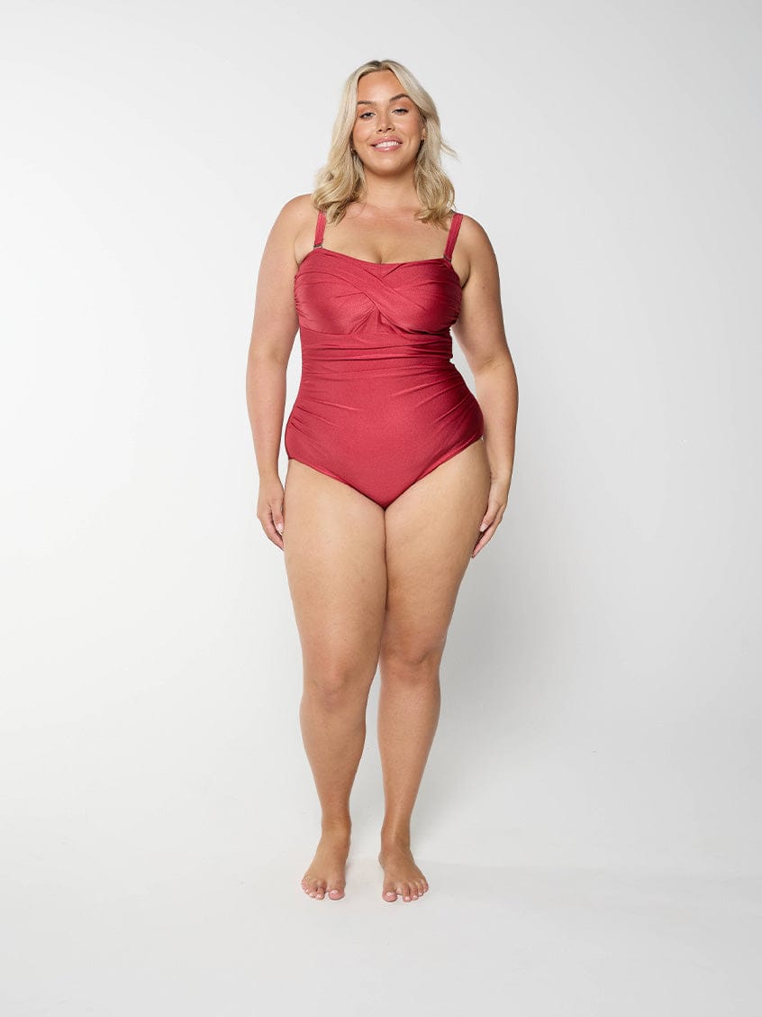 Front of curve blonde model wearing a bandeau one piece with removable and adjustable straps