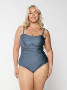 Blonde model in studio wearing grey one piece bandea for curve woman