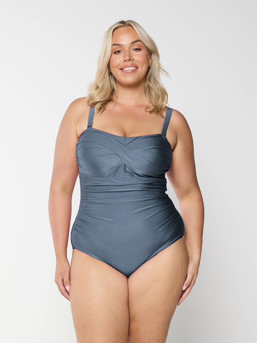 Blonde model in studio wearing grey one piece bandea for curve woman