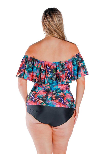 Back view of blonde model wearing pink and blue floral print off shoulder tankini with straps off