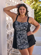 Brunette woman by pool wearing a chlorine resistant paisley swim dress with wide strap adjustable straps