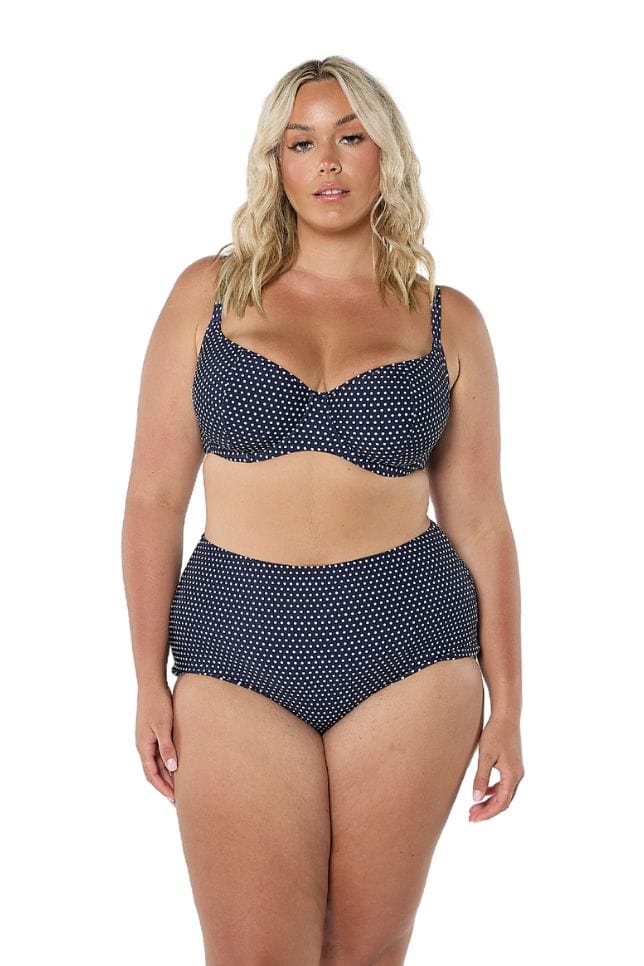 Front of model in studio wearing navy white spotted bikini bottom
