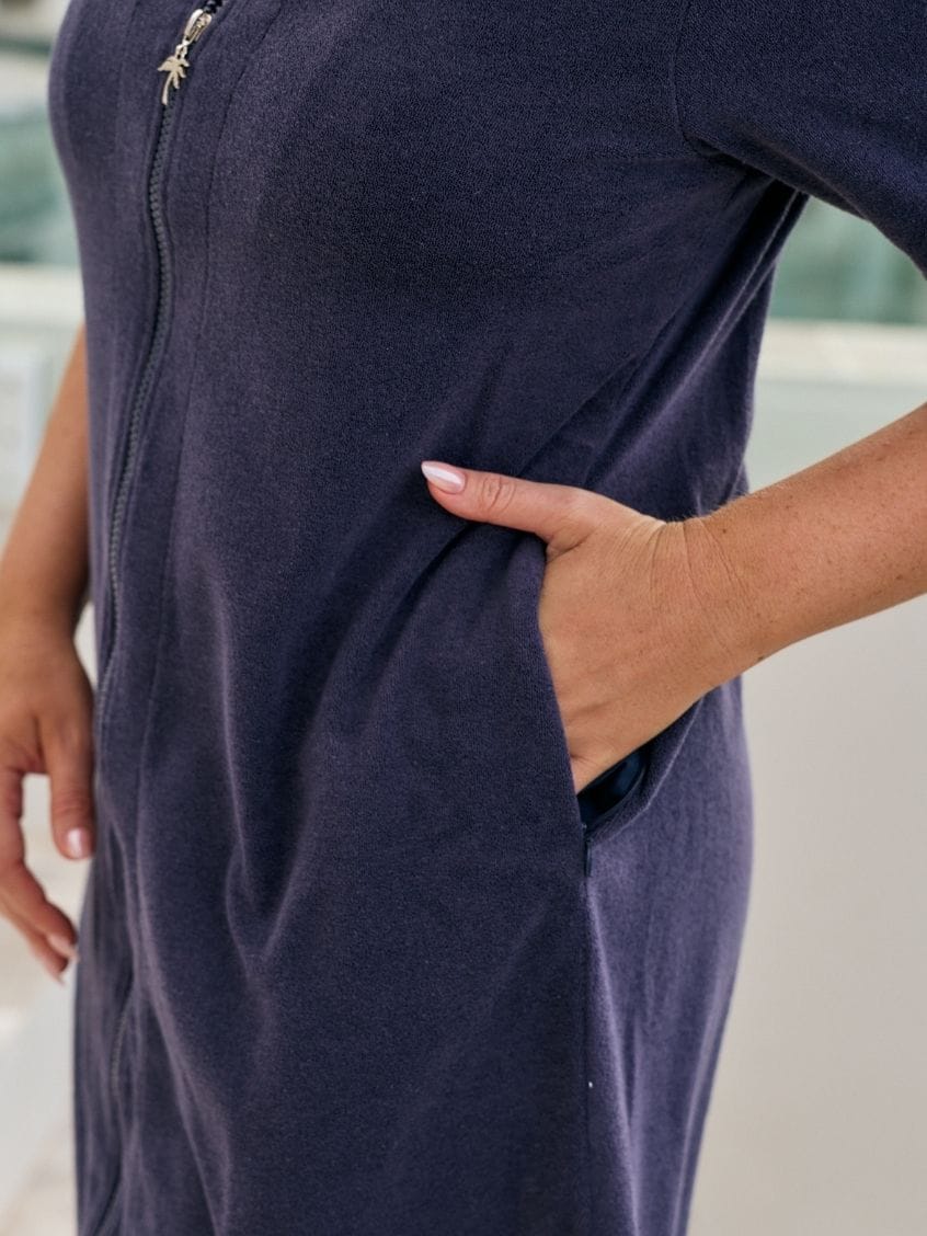 Close up of terry towelling dress with pockets and zip detail