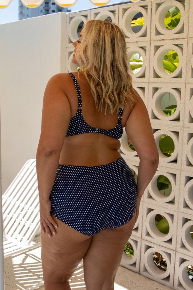 Back of model wearing tummy control high waisted pant for curve women