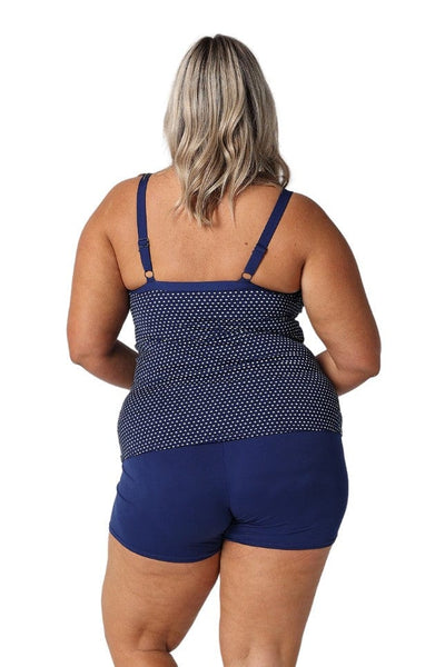 Back of model in studio wearing curvy tankini top with polkadots and adjustable straps

