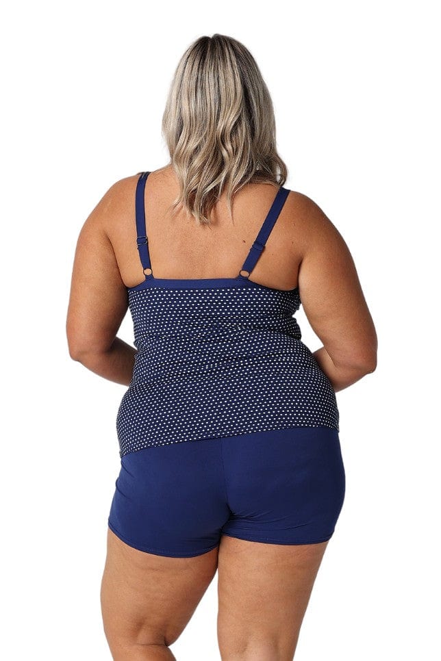 Back of model in studio wearing curvy tankini top with polkadots and adjustable straps
