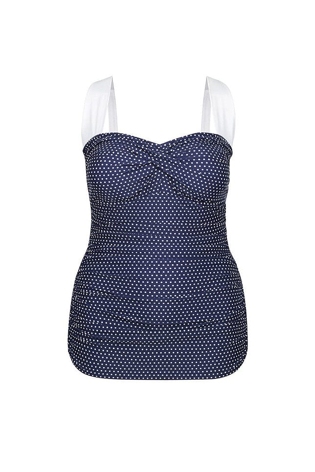 ghost mannequin of a retro skirted one piece in navy and white dots with white straps
