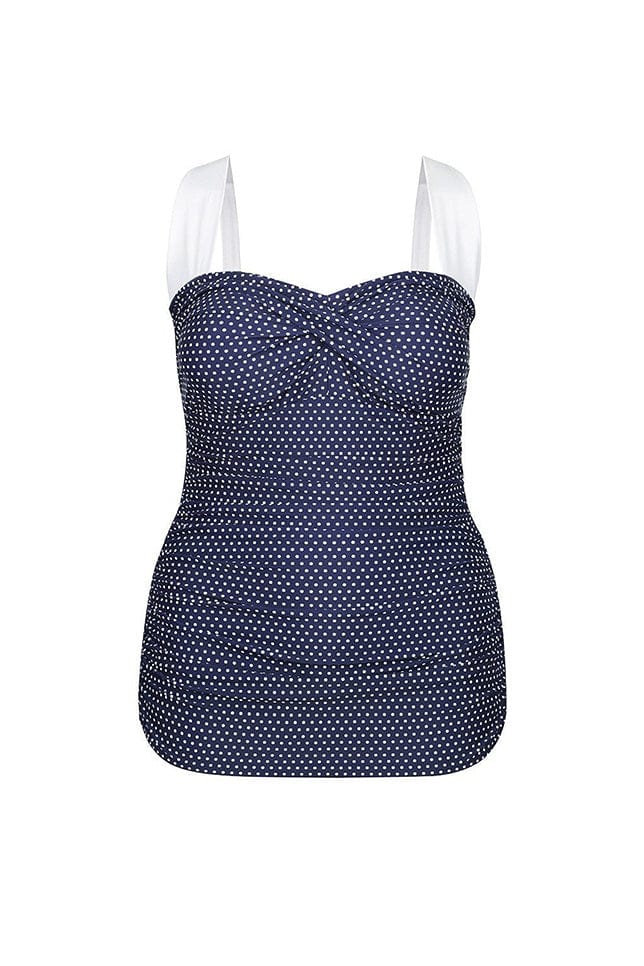 ghost mannequin of a retro skirted one piece in navy and white dots with white straps