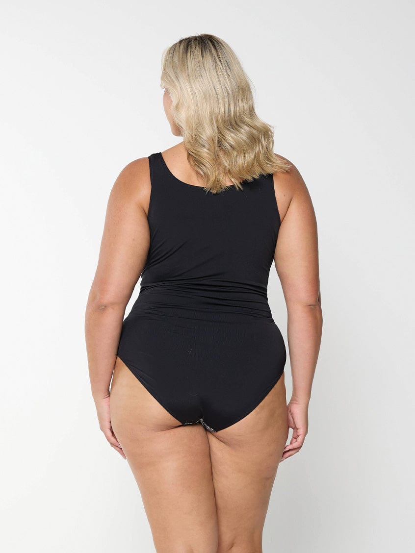 Back of model wearing high back one piece with zip front detail in paisley chlorine resistant