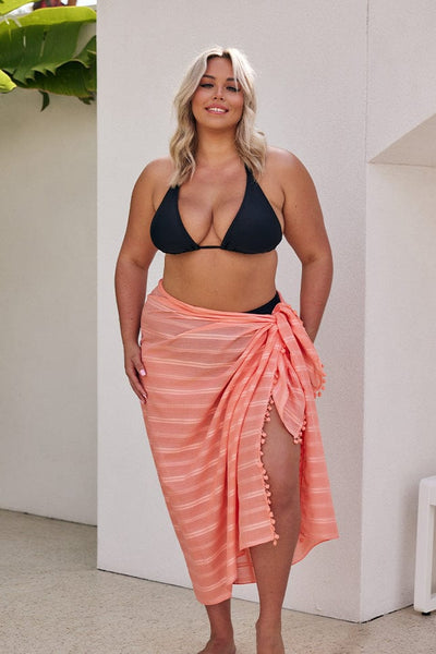 Blonde model wearing coral coloured sarong