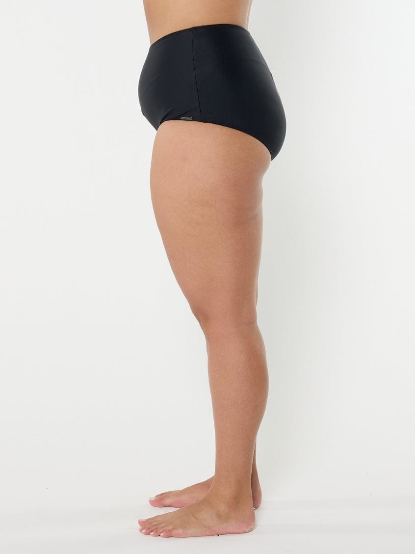 Person wearing black high-waisted underwear on a white background